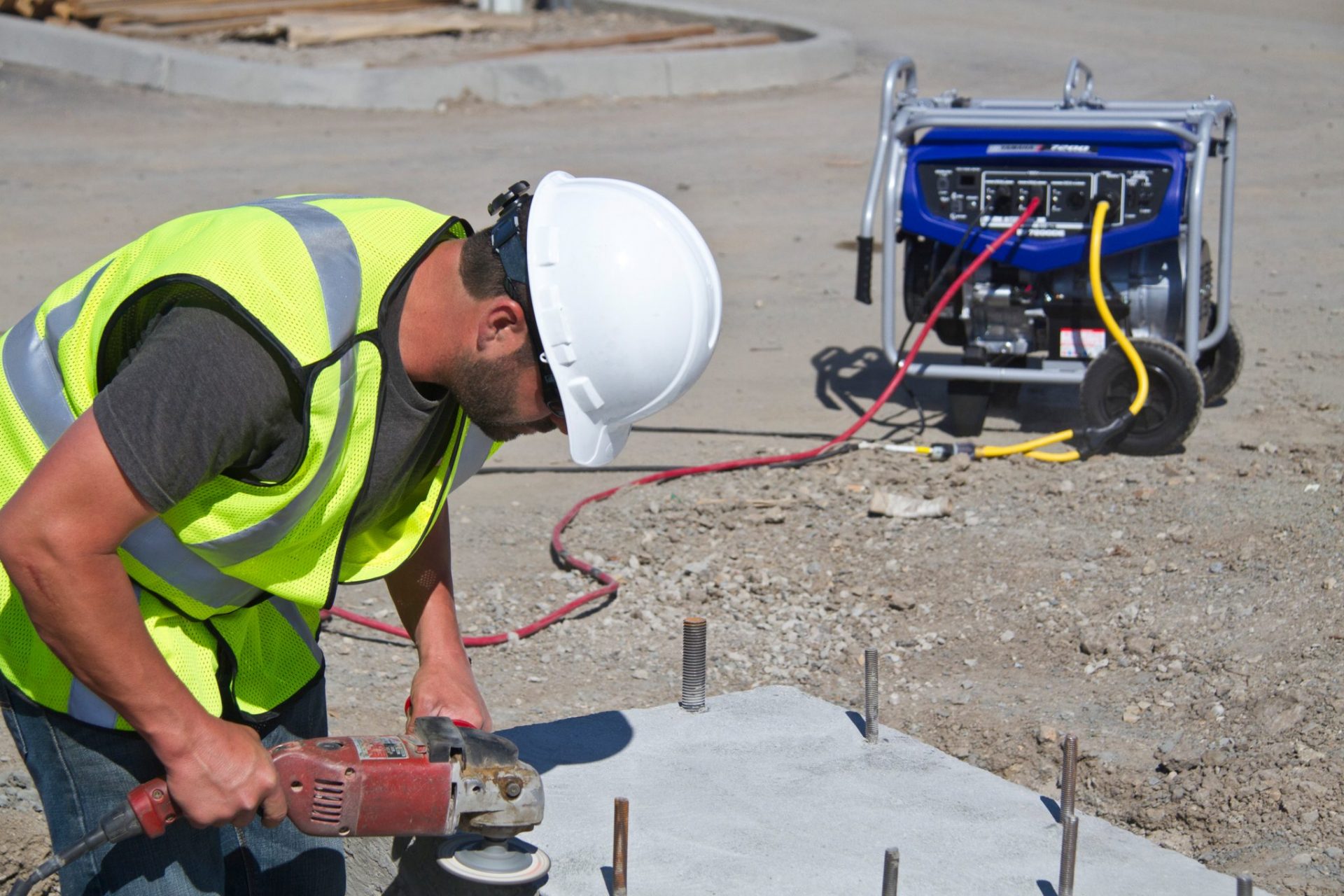 Construction worker with generator in the background